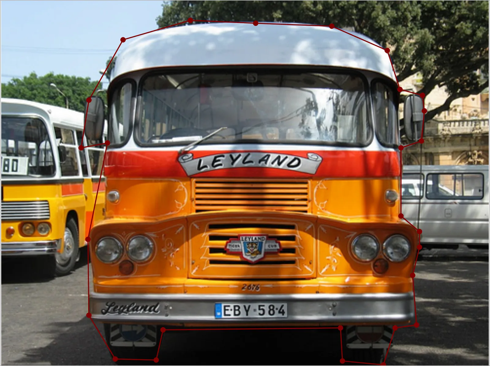 Offscreen Labelme canvas showing the same orange bus annotated with a 27-vertex polygon that follows the mirrors, the roof curve and the gap under the bumper.